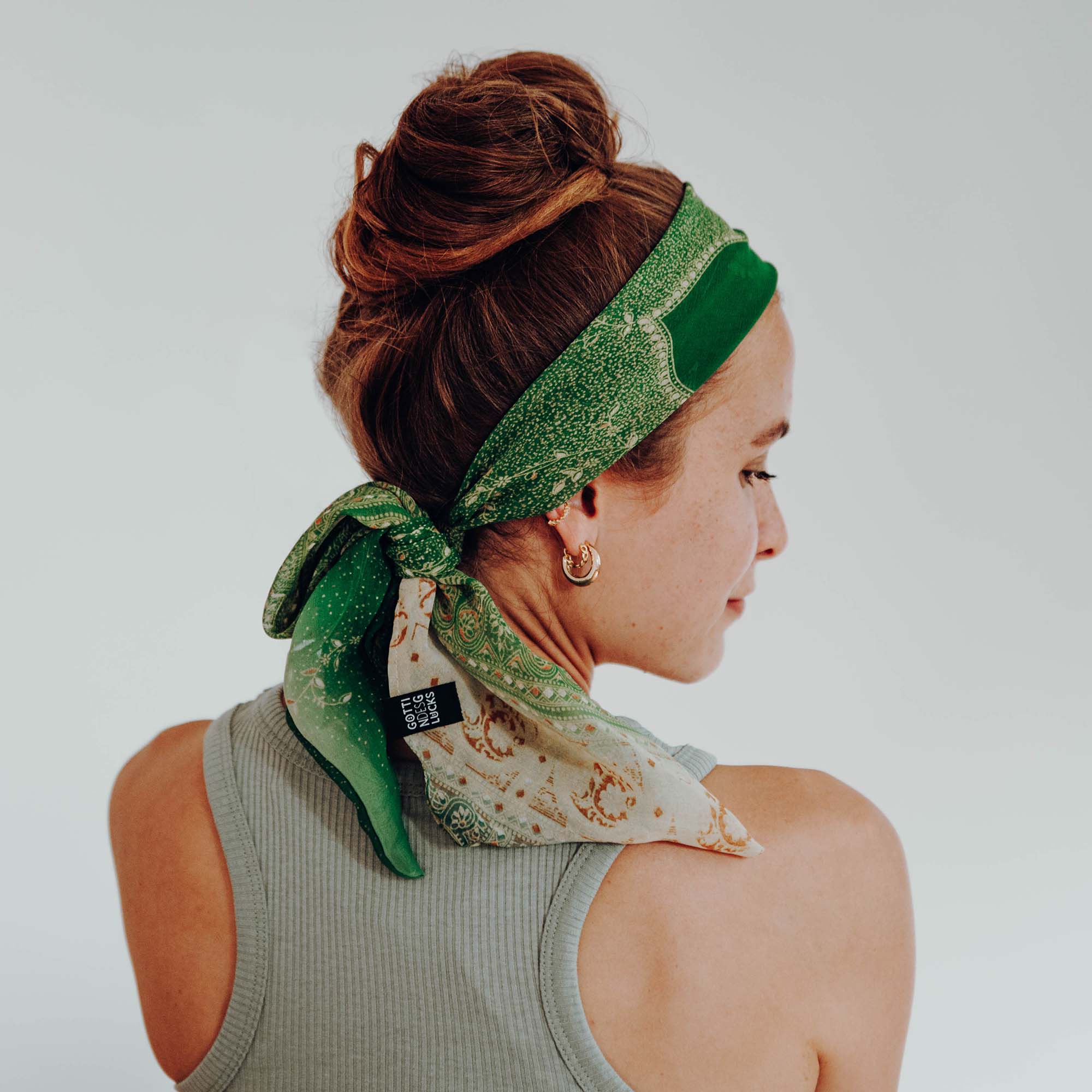 Lady with a colourful FAIR SQUARED hairband made from reused sari fabric